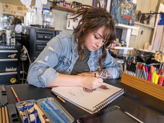 Artist working on tattoo design
