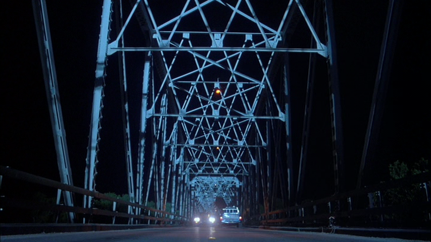 Texas Chainsaw Massacre 2 screengrab, showing a car chase on a Bridge at night