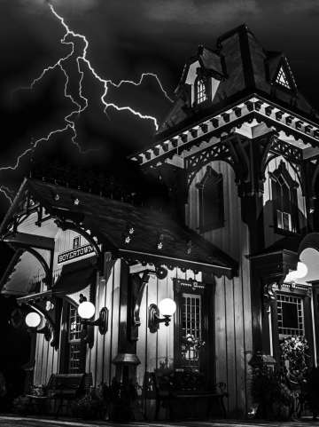 Black and white photo of the Colebrookdale Railroad station with lightning in the sky in the background
