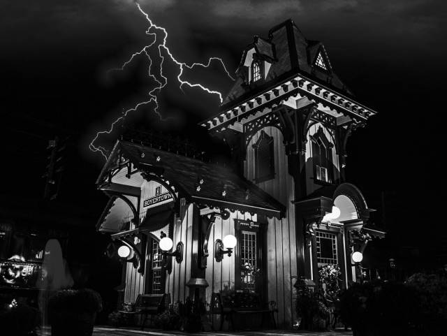 Black and white photo of the Colebrookdale Railroad station with lightning in the sky in the background