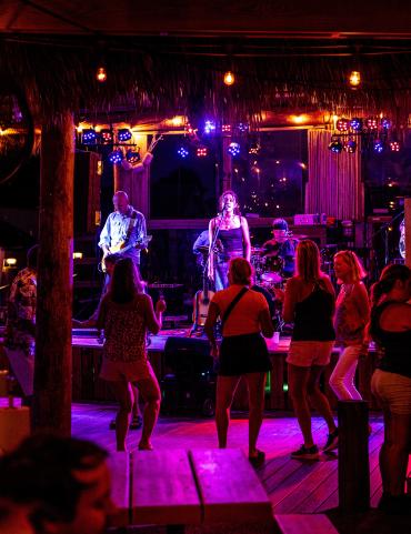 People dancing to live music at SandBar Tiki & Grill in Englewood, Florida