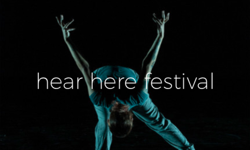 A person dances with text overlay that reads hear here festival.
