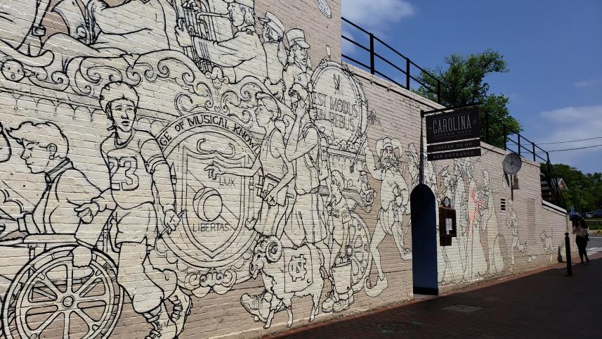 Parade of Humanity Mural by artist Michael Brown locate at Carolina Coffee Shop in Chapel Hill