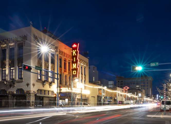 Nighttime photos of the neon-lit KiMo Theatre.
