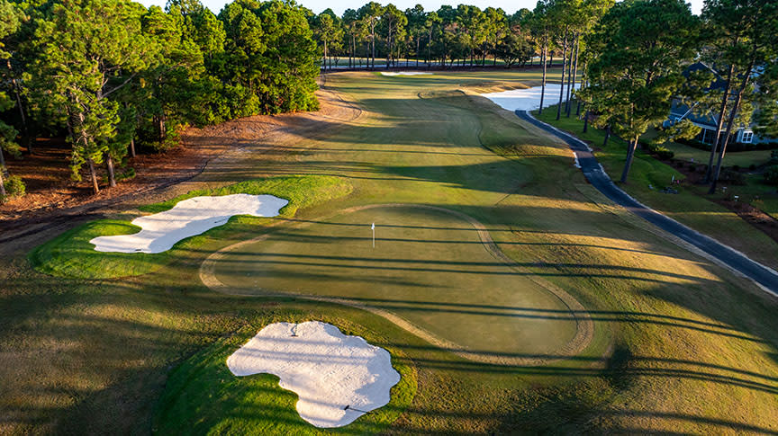 an aerial view of a green on the Willard course at Sea Trail golf resort