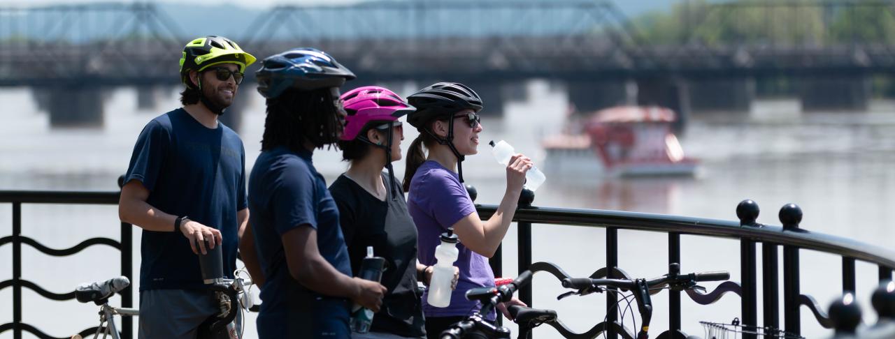 Bikers on Riverfront w Riverboat Background