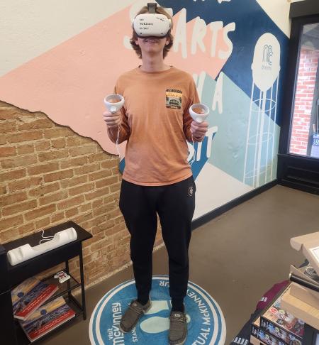Young man wearing VR goggles in visitors center
