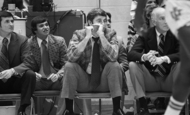 Black and white photo of coaches at game