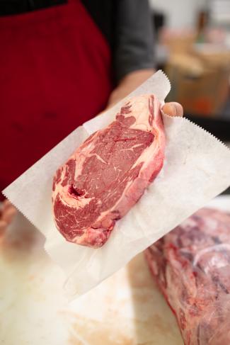 Piece of raw beef on a sheet of waxed paper
