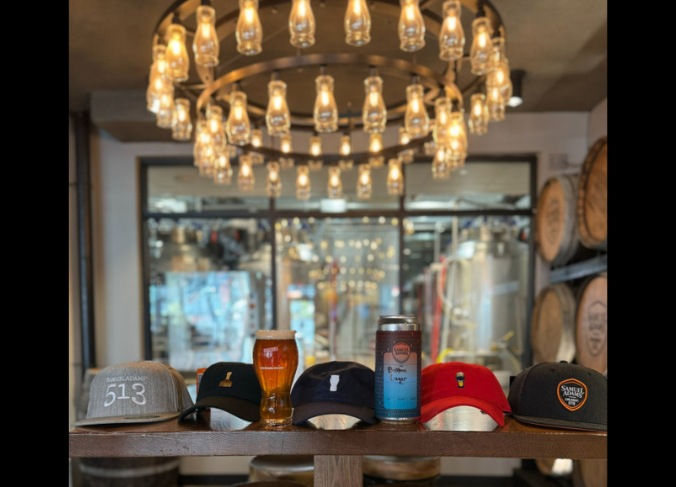 Image is inside the Samuel Adams tap room looking at hats and beer.
