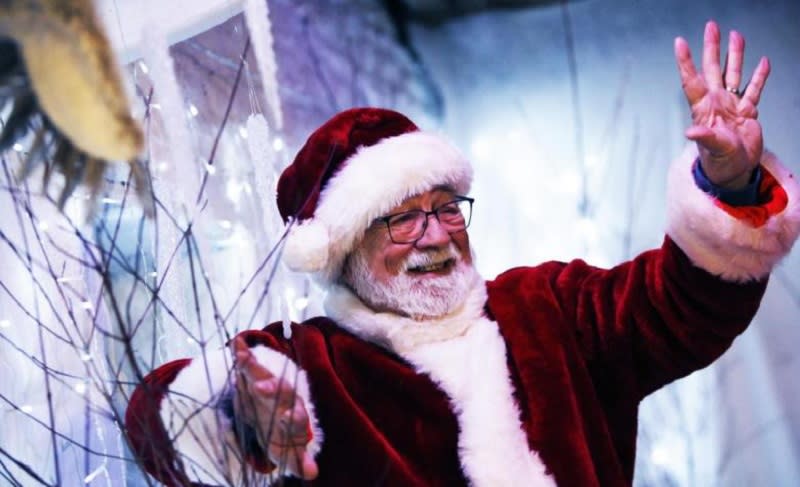 Father Christmas waves at people off camera