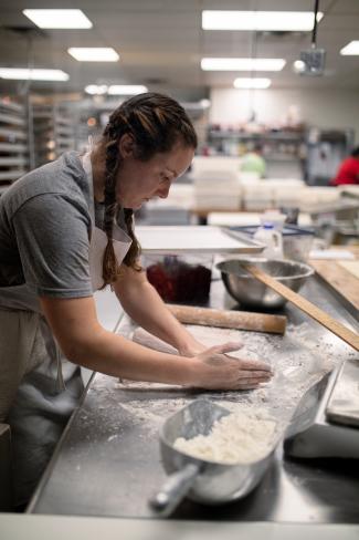 woman in braids making bread
