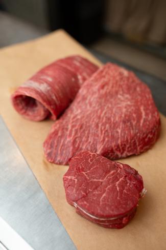 three cuts of raw beef sitting on butcher paper