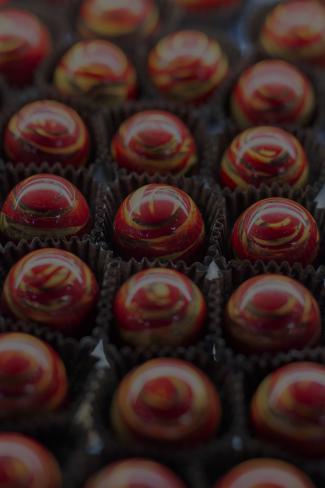 red truffle candies with yellow swirls on top