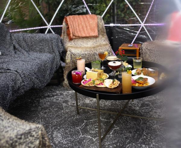 Interior of an igloo at VASO with a variety of food on the table.