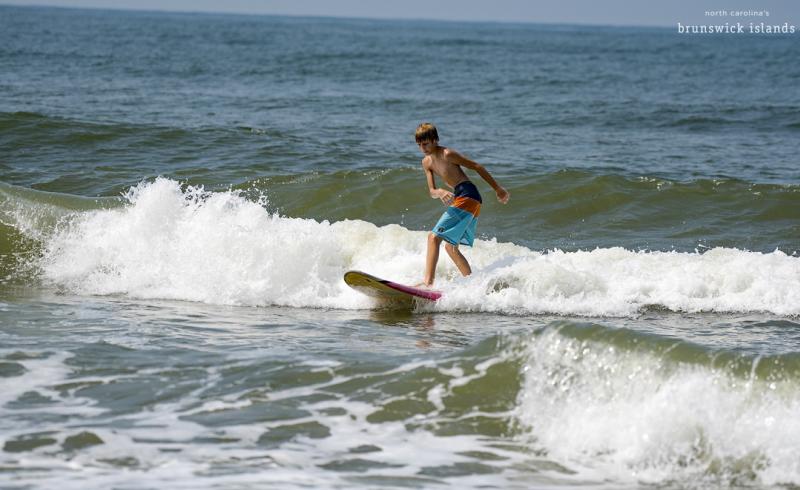 Boy surfing in Oak Island, North Carolina.