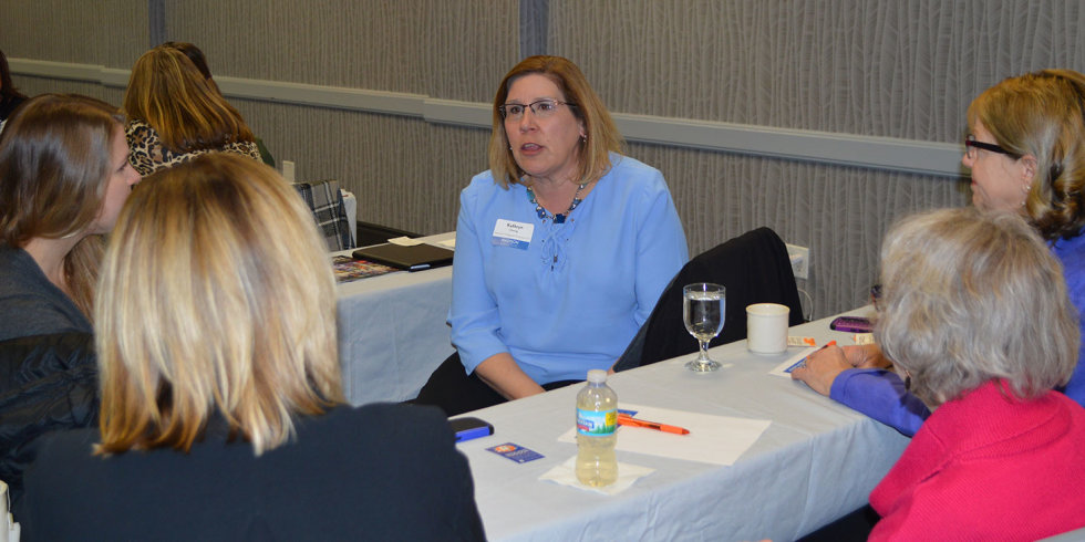 A group of women chat around a table at the March 2018 Industry Insider Training