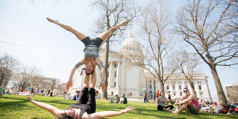 Two people do yoga in the Capitol Lawn in Madison, Wisconsin