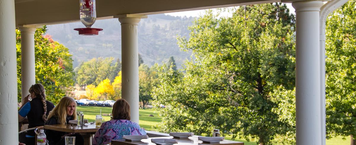 People dining on the outdoor patio at the Chautauqua Dining Hall