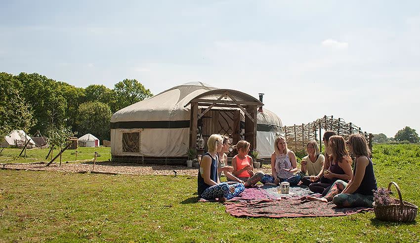 Women sitting outside at the Yoga Garden