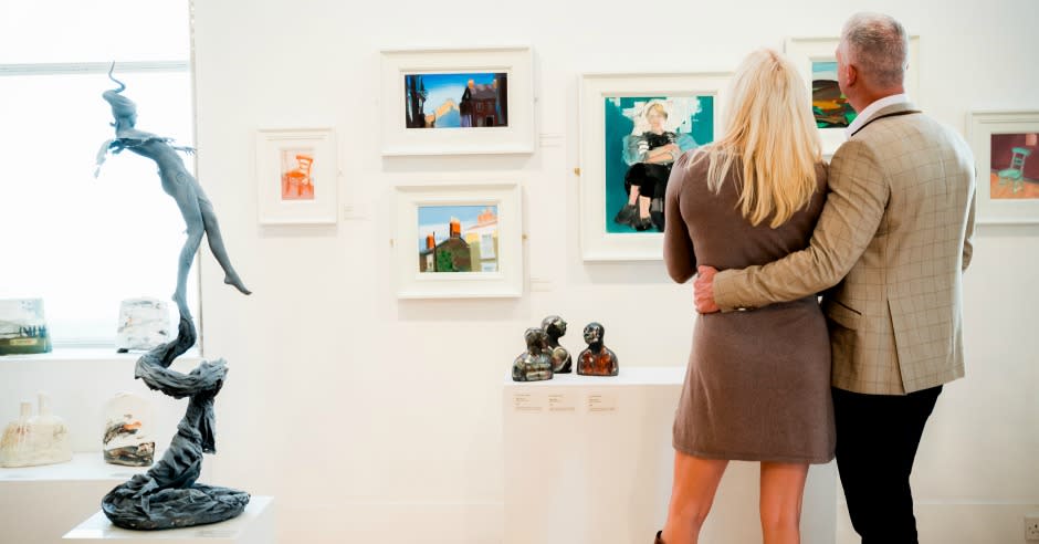 A couple looking at art on display at Royal Cambrian Academy