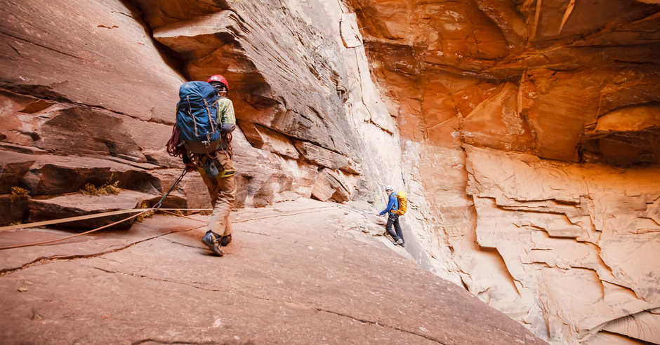 Two climbers hiking through Mystery Canyon in Zion National Park