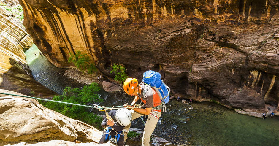 Two climbers repelling down Mystery Canyon in the Virgin River Narrows, Zion National Park