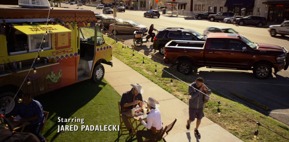 Walker screengrab showing Walker and Micki eating in front of a brightly colored food truck on South Congress Avenue. A credit is in the left corner, reading Starring Jared Padalecki