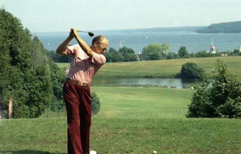 President Gerald R. Ford tees off the Jewel golf course at Mackinac Island’s Grand Hotel overlooking the blue Straits of Mackinac