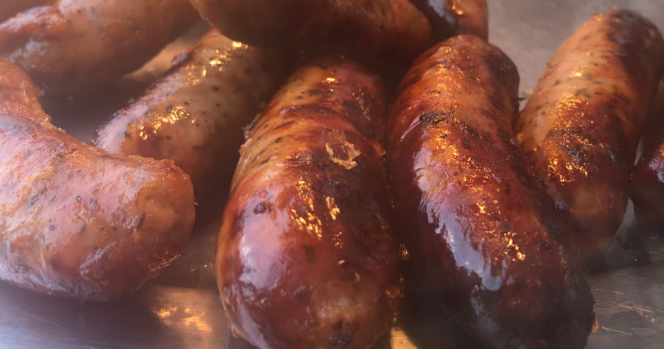 close-up picture of freshly made sausages on a tray