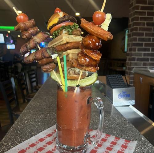 Bloody Mary with huge garnish sitting on bar top