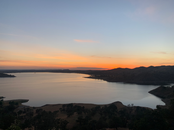 Orange sun sets over view of Millerton Lake