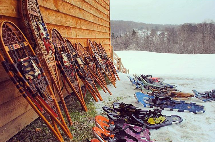 Snowshoes lined up against a building