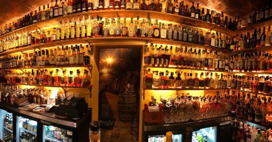 Hundreds of bottles of bourbon at the Old Prohibition Bourbon Bar in Northern Kentucky, lit with a golden light.