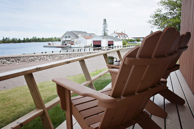 two chairs sit invitingly on a porch