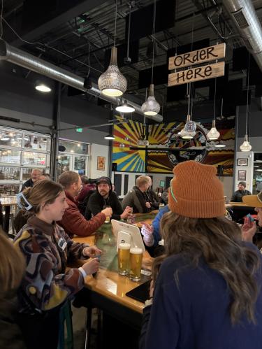 Over Yonder Brewing Company people sitting around the bar talking and drinking beer