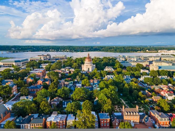 an aerial view of historic Annapolis and the Naval Academy Chapel with the Severn River behind it.