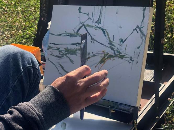 An artist creates a painting in the Deale Plein Air Festival