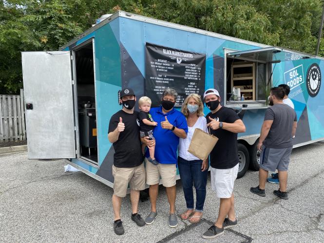 The O'Leary Family lines up in front of the Black Market Bakers Food Truck.