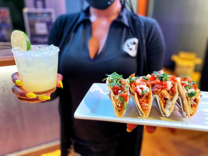 Drinks and tacos are served