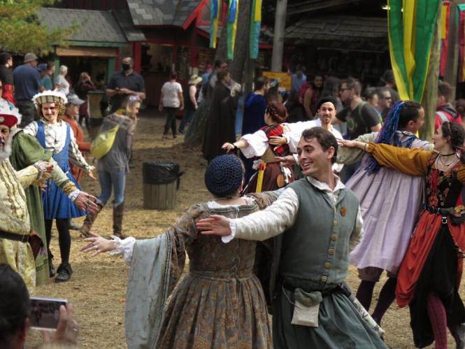 Image of people in Renaissance era clothing dancing at the Maryland Renaissance Festival