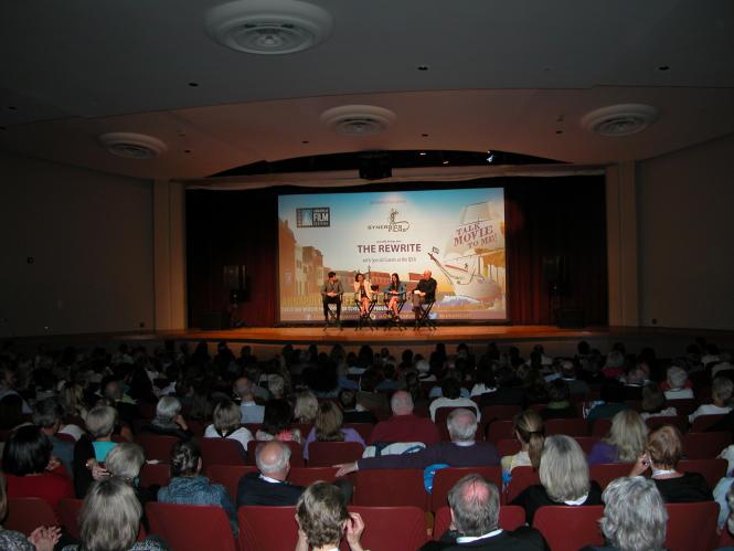 A stage with people on it talking about a film.