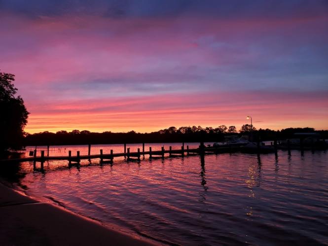 A gorgeous sunset at cove with a pier