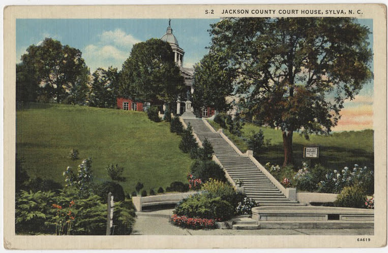Vintage linen postcard of the Jackson County Courthouse in Sylva, NC, with its long stone staircase climbing a grassy hill to the domed courthouse