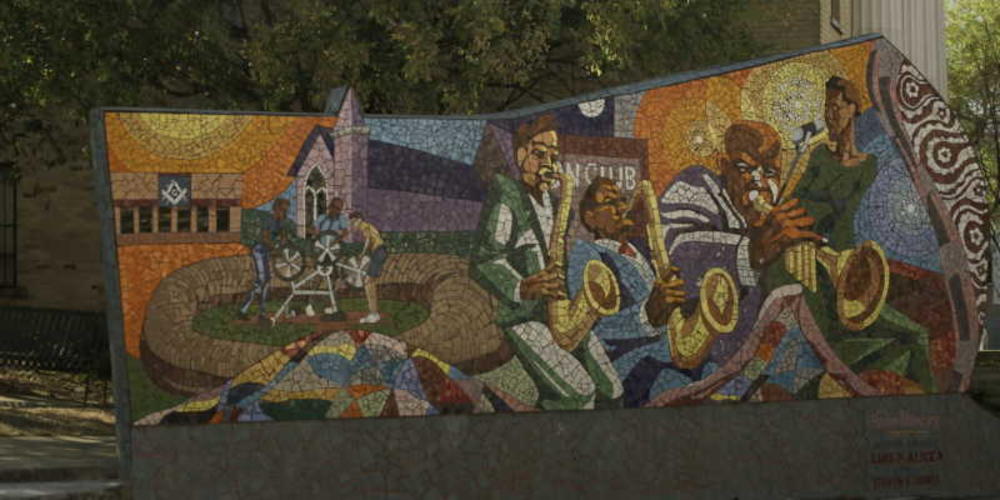 Walker screengrab showing the Rhapsody mosaic in East Austin. The mosaic displays musicians playing brass instruments