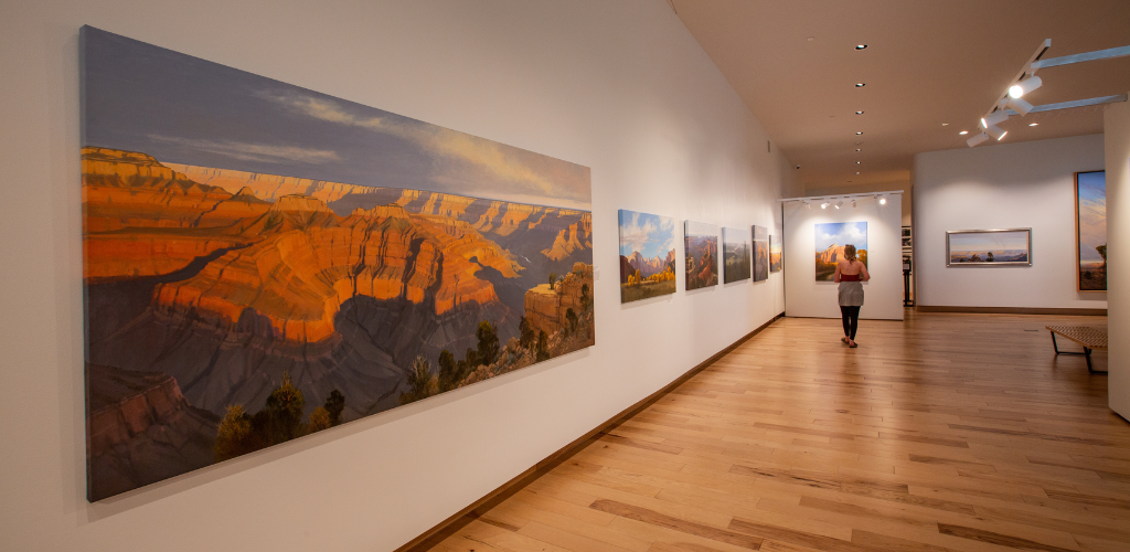 Interior of the Southern Utah Museum of Art in Cedar City with vibrant landscape paintings showcased