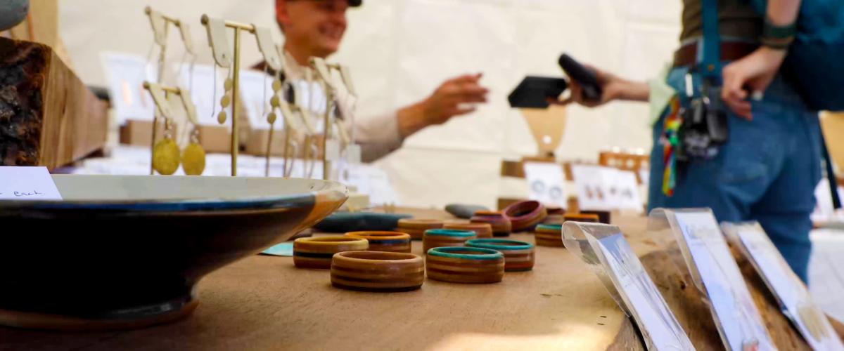 An individual buying art at the Grand Marais Art Festival
