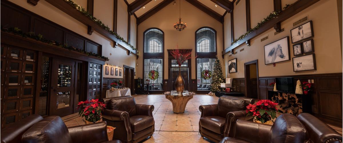 Main lobby with wood accents, leather couches and poinsettias