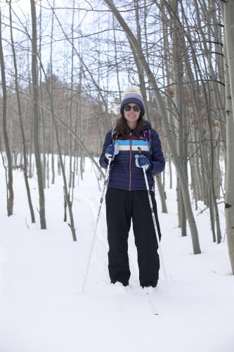 Dani smiling on the cross-country ski trails, aspens