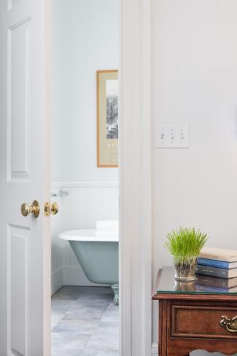 Portion of bathtub through open bathroom door